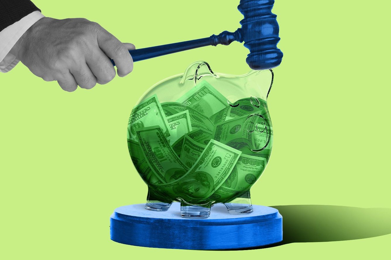 Gavel over transparent piggy bank
